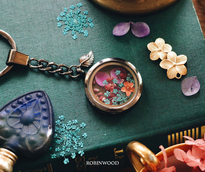 " December Collection's " Mystery Flower Design, Black Locket Keychain, Robinwood